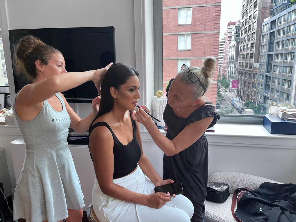 A hair stylist and makeup artist prep Real Housewives of New York star Jessel Taank for a New York Fashion Week show.