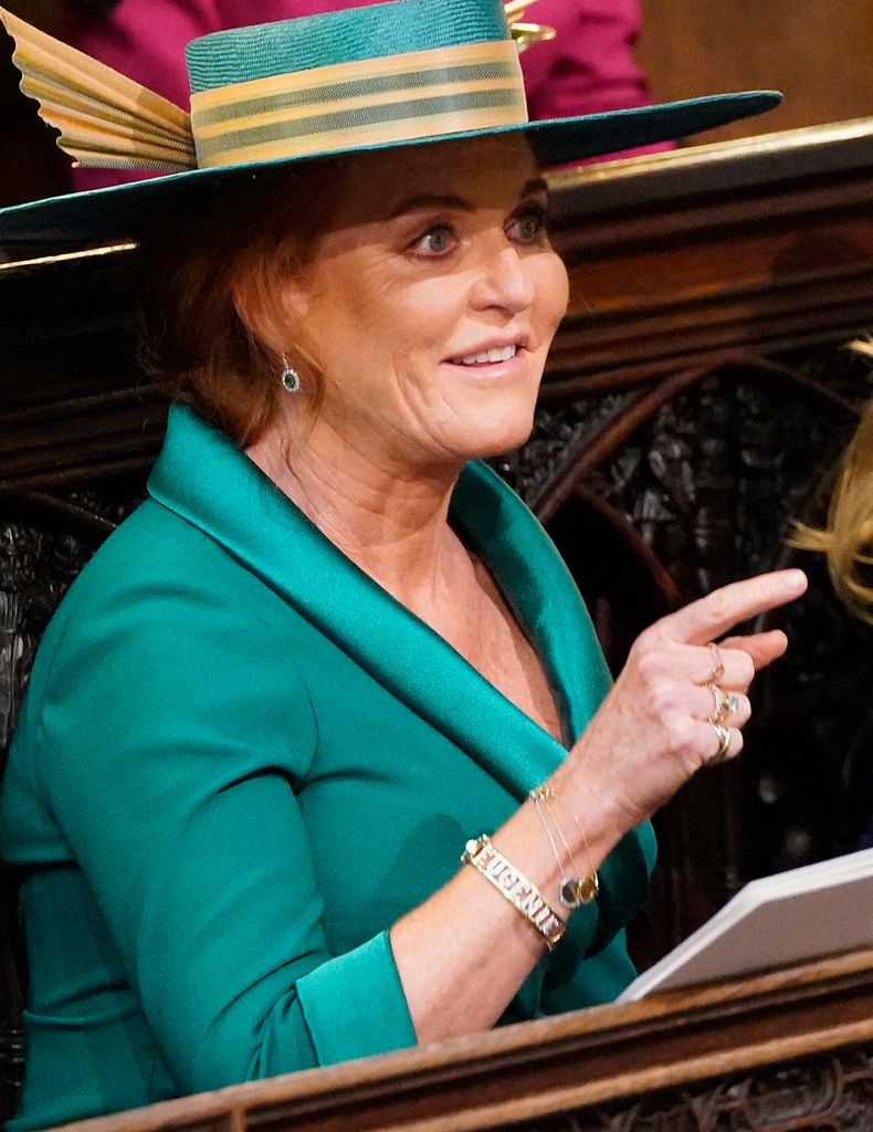 The Duchess of York pointing in a green dress