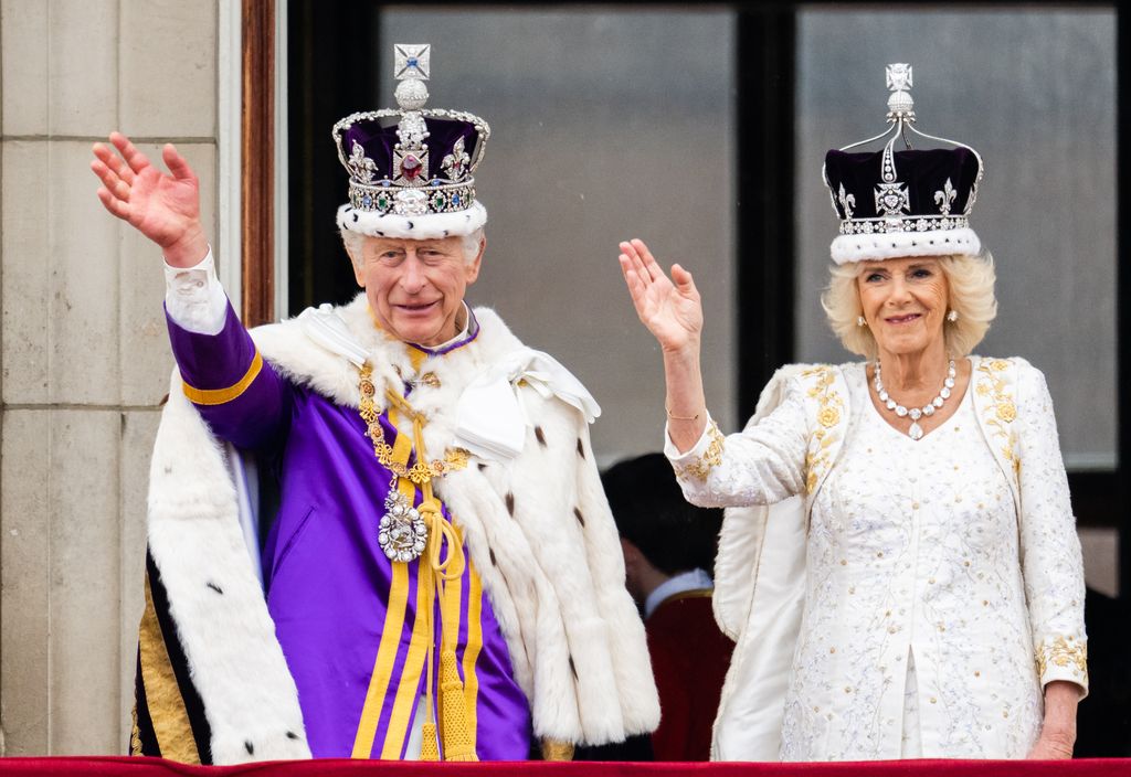 King Charles and Queen Camilla waving from palace balcony on coronation day