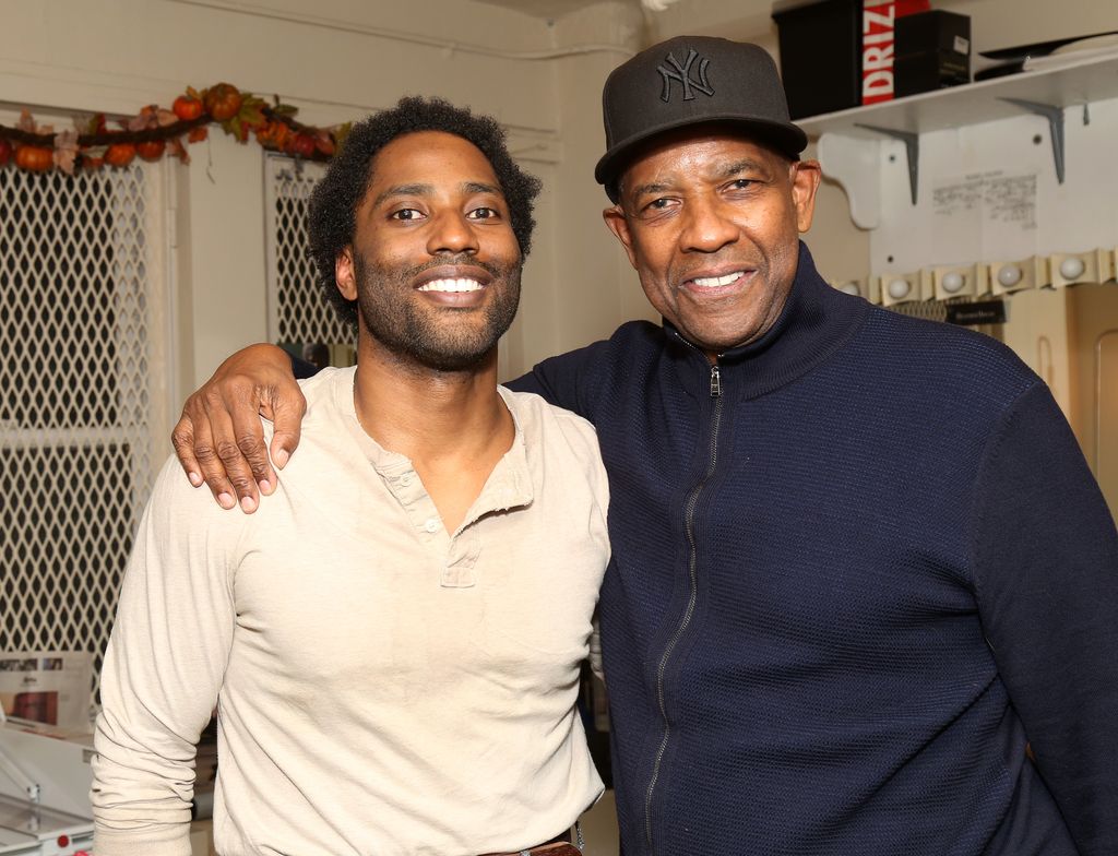 John David Washington and father Denzel Washington pose backstage at the play "The Piano Lesson" on Broadway at The Barrymore Theater on November 18, 2022 in New York City