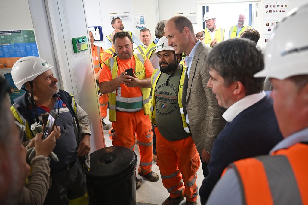 Prince William meets workers during a visit to a construction site
