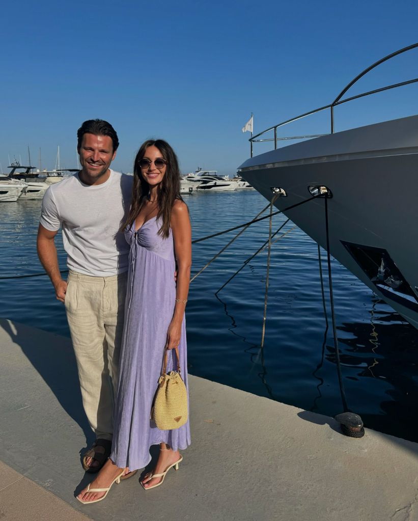 couple posing by water on holiday