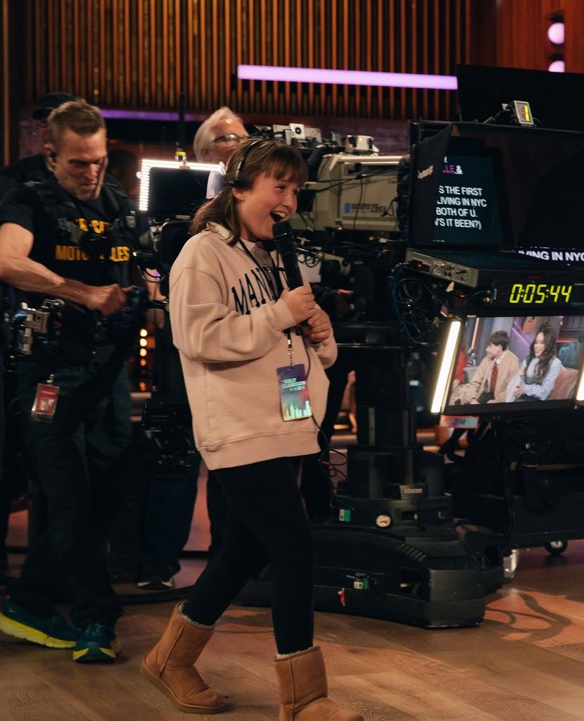 Kelly Clarkson's daughter River Rose speaks on the mic on the set of The Kelly Clarkson Show on NBC