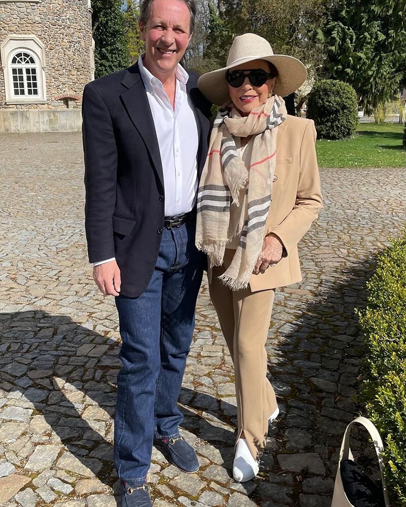 Joan Collins posing with husband Percy Gibson