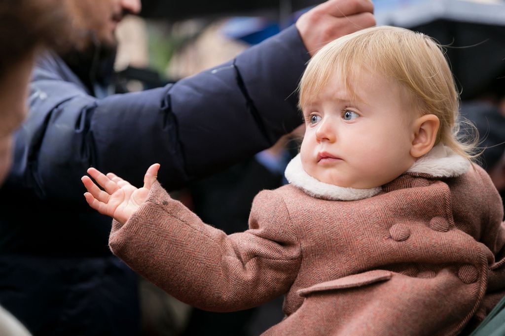 A young girl waving