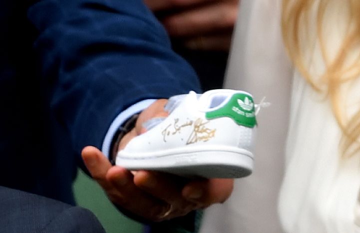Stan Smith gives Catherine a signed baby 'Stan Smith' trainer in the Royal Box during Men's Finals Day at Wimbledon