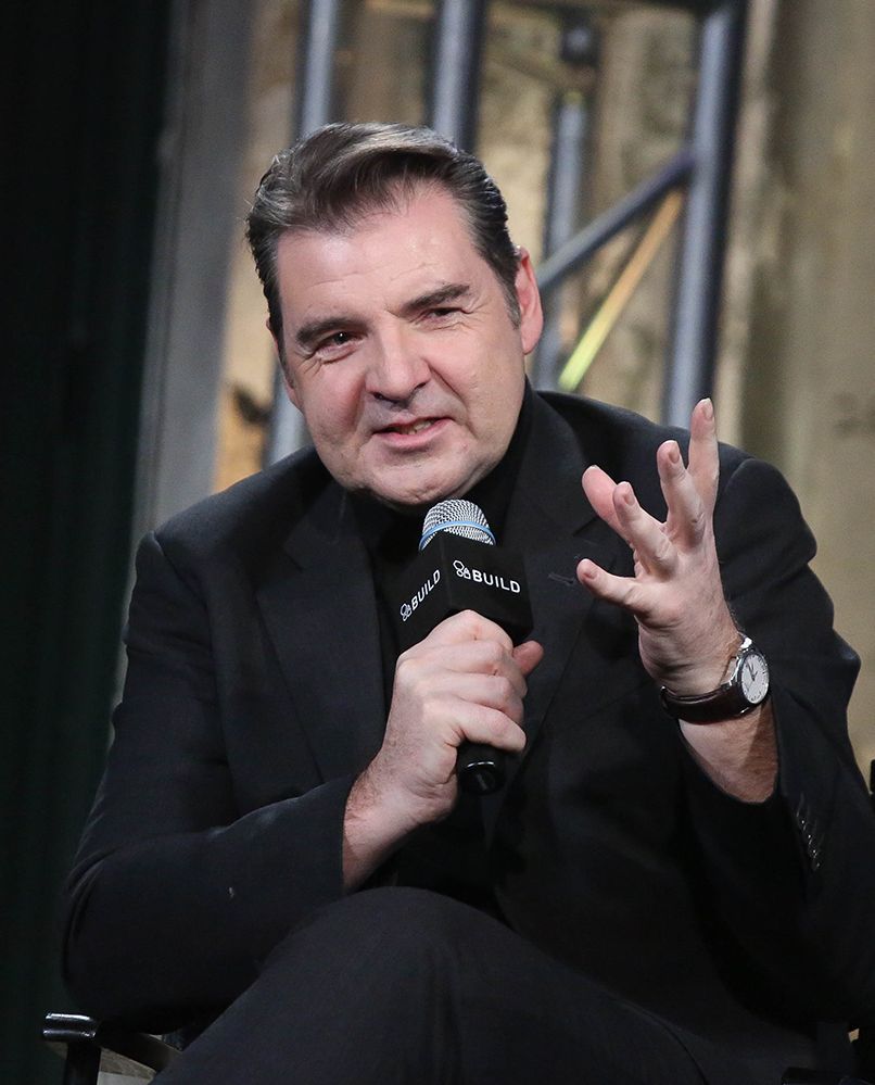 Brendan Coyle wearing a black suit