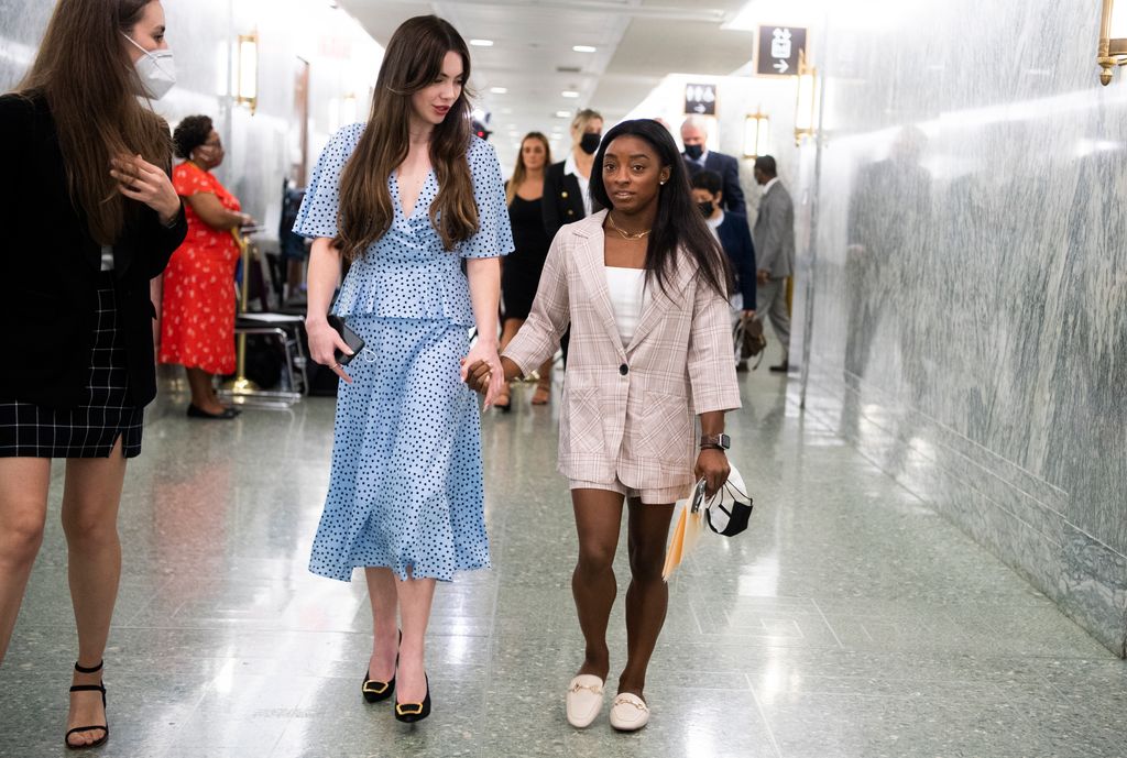 McKayla Maroney and Simone Biles hold hands as they leave the Senate Judiciary Committee hearing titled Dereliction of Duty: Examining the Inspector Generals Report on the FBIs Handling of the Larry Nassar Investigation