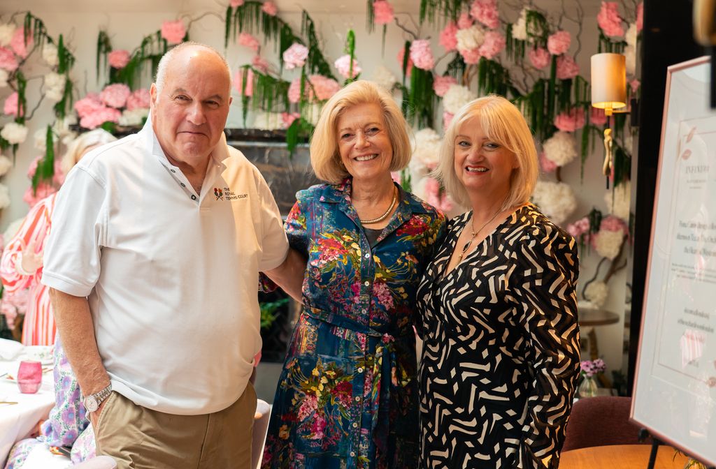 two women and a man in floral room