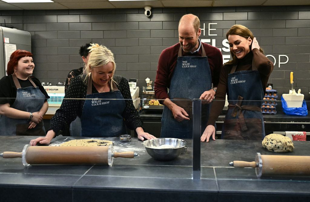 William and Kate react as prepare to make Welsh Cakes, watched by Theresa Connor, owner of the The Welsh Cake Shop  