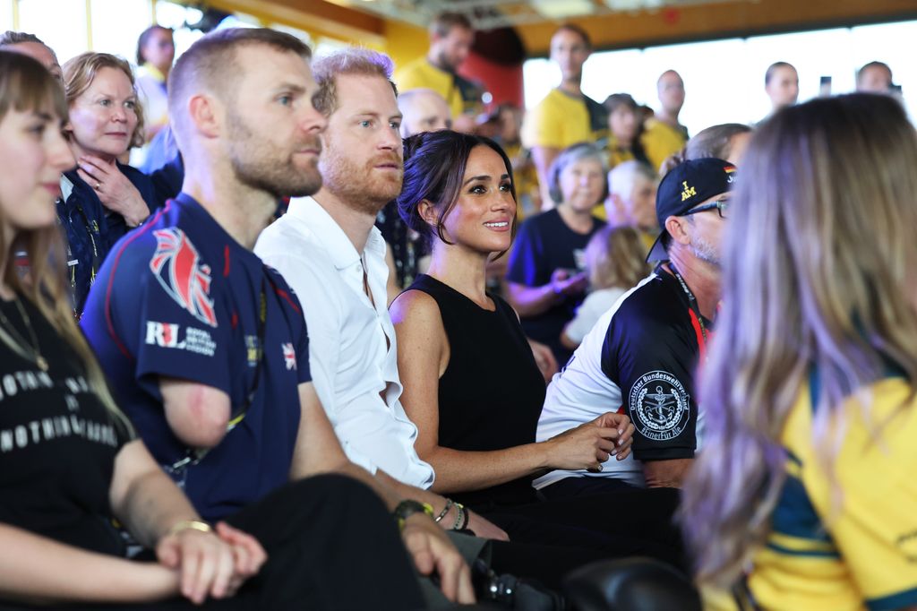 Prince Harry and Meghan Markle sitting with Mark Omrod