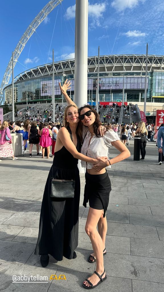 The actress posed outside the stadium with a friend
