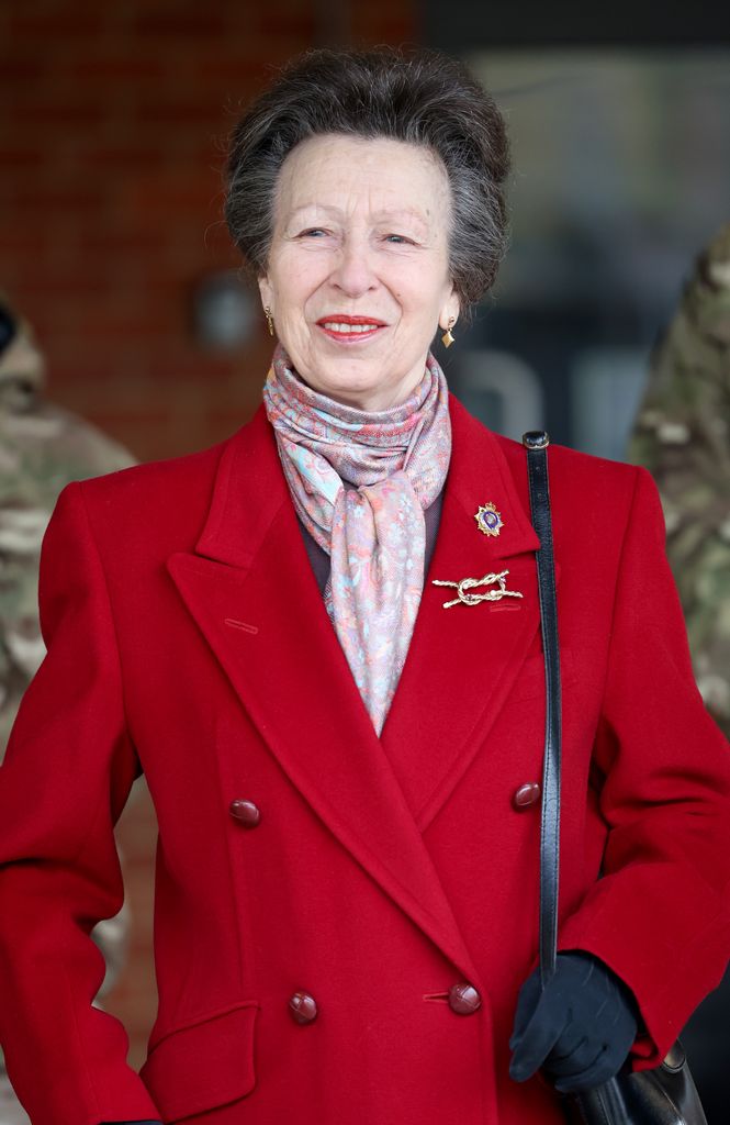Princess Anne in red coat and patterned scarf