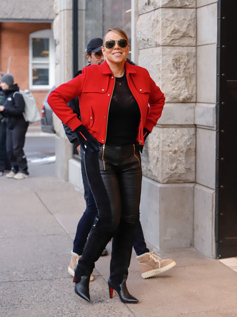 Mariah Carey in black skinny jeans and red cropped jacket