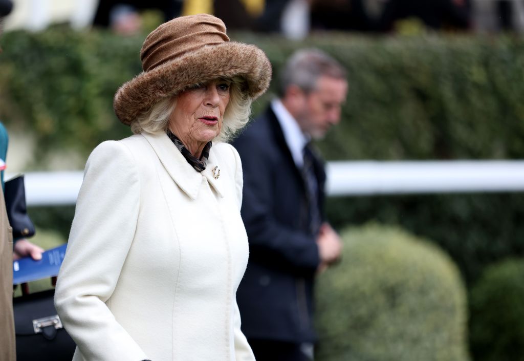 woman in white coat and fur hat at ascot 