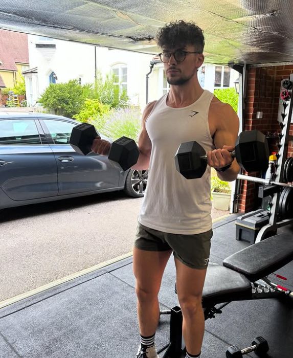 Jack Butler working out with weights in his garage