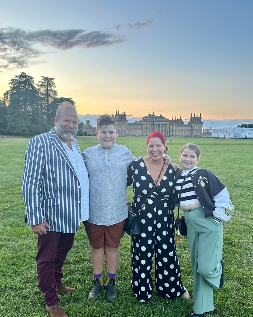 family of four posing on lawn 