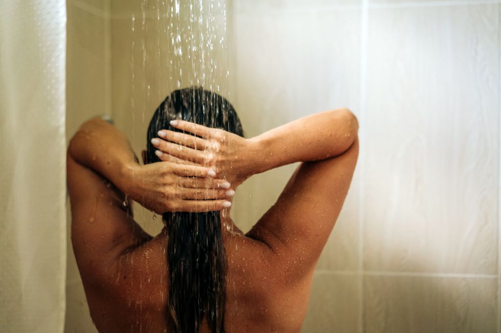 Woman in the hotel room having a shower