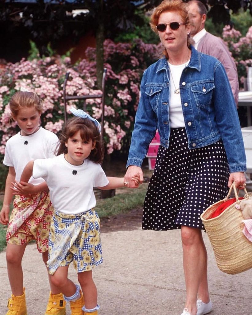  A young Eugenie walking hand-in-hand with Sarah and her older sister Princess Beatrice