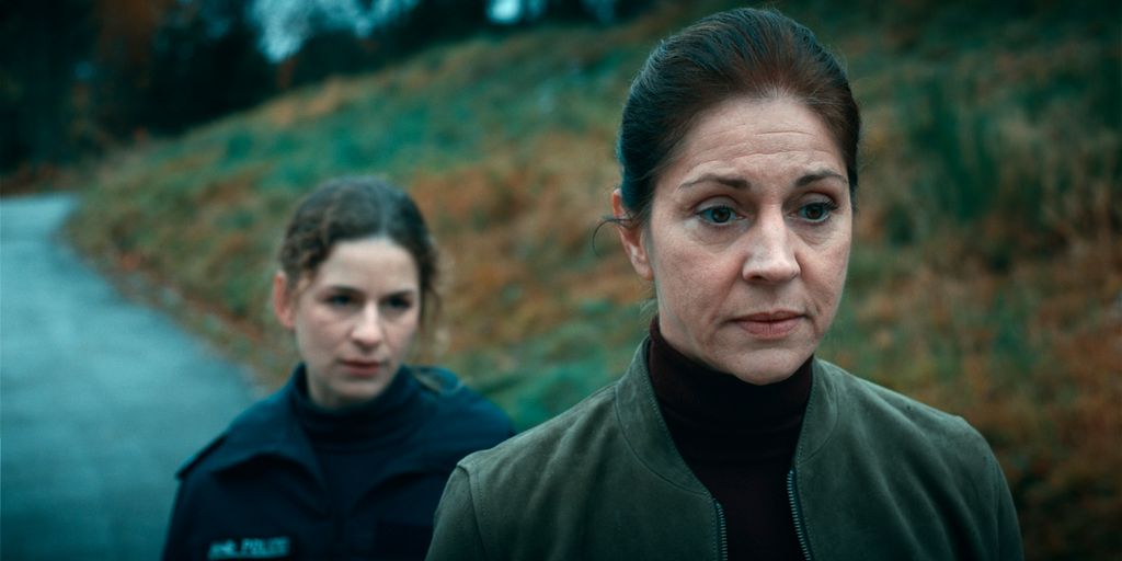 two women standing on road