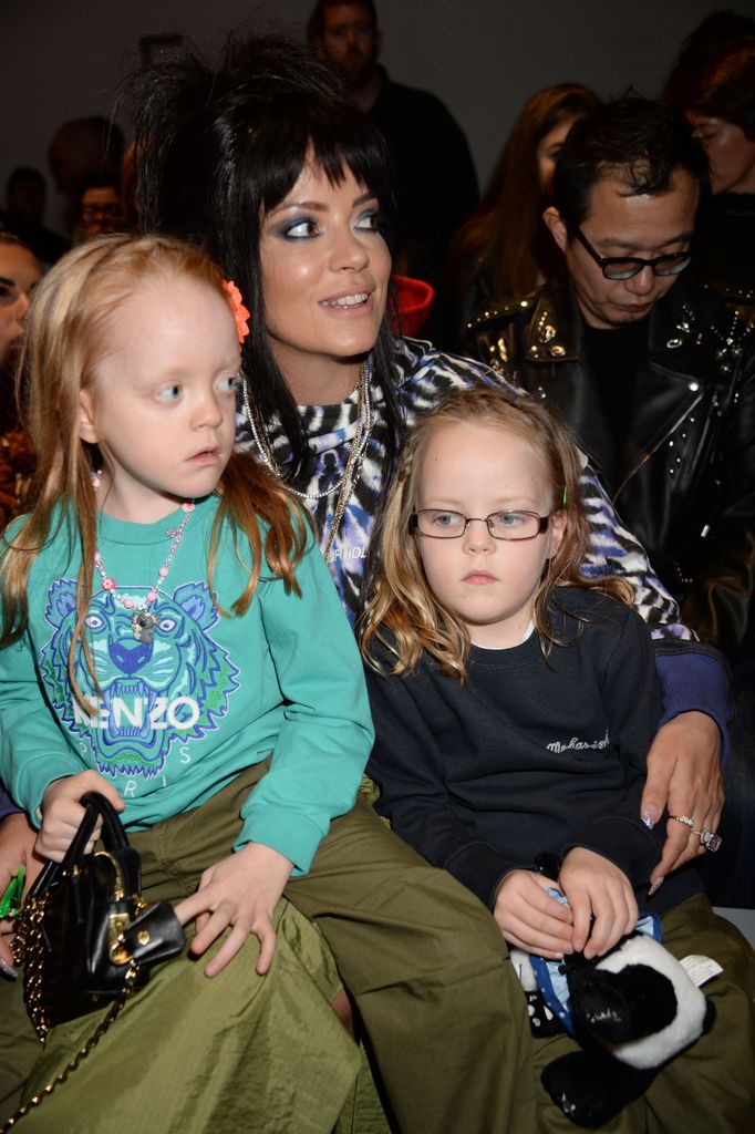 Lily Allen with her daughters on her knee