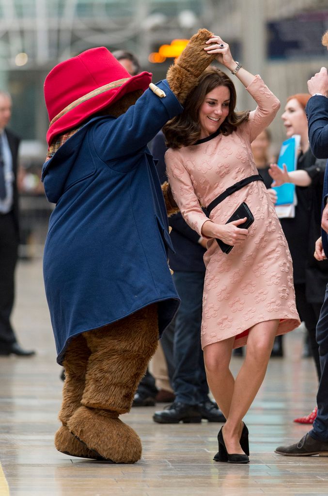 Kate dances with Paddington Bear at the Charities Forum Event on board the Belmond Britigh Pullman train at Paddington Station in 2017