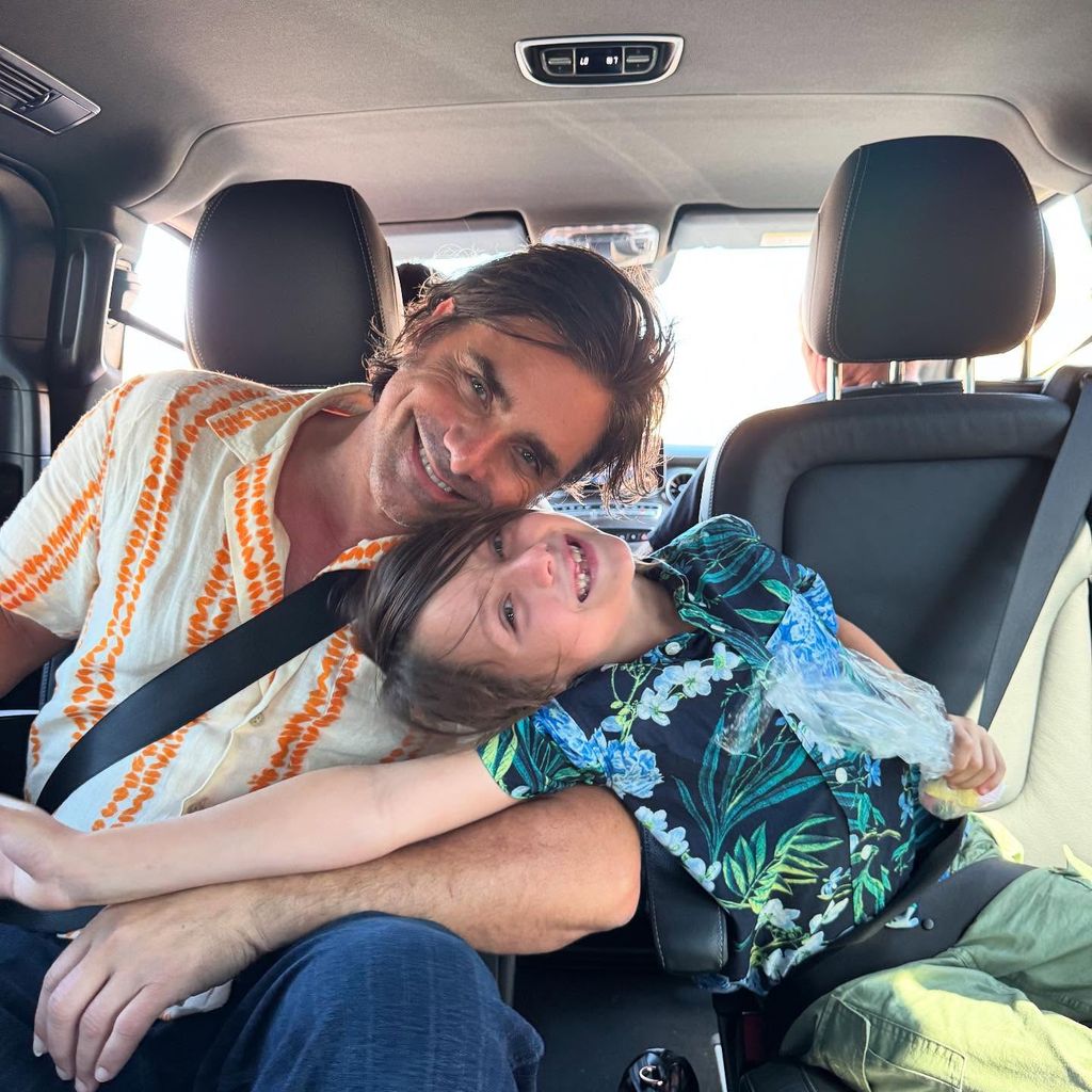 john stamos sitting in the back of a car leaning against his son billy