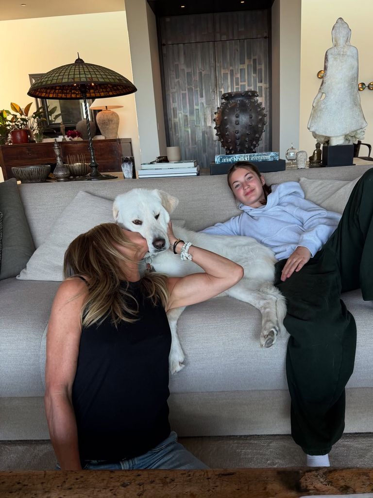 Jennifer in living room with girl and dog on sofa