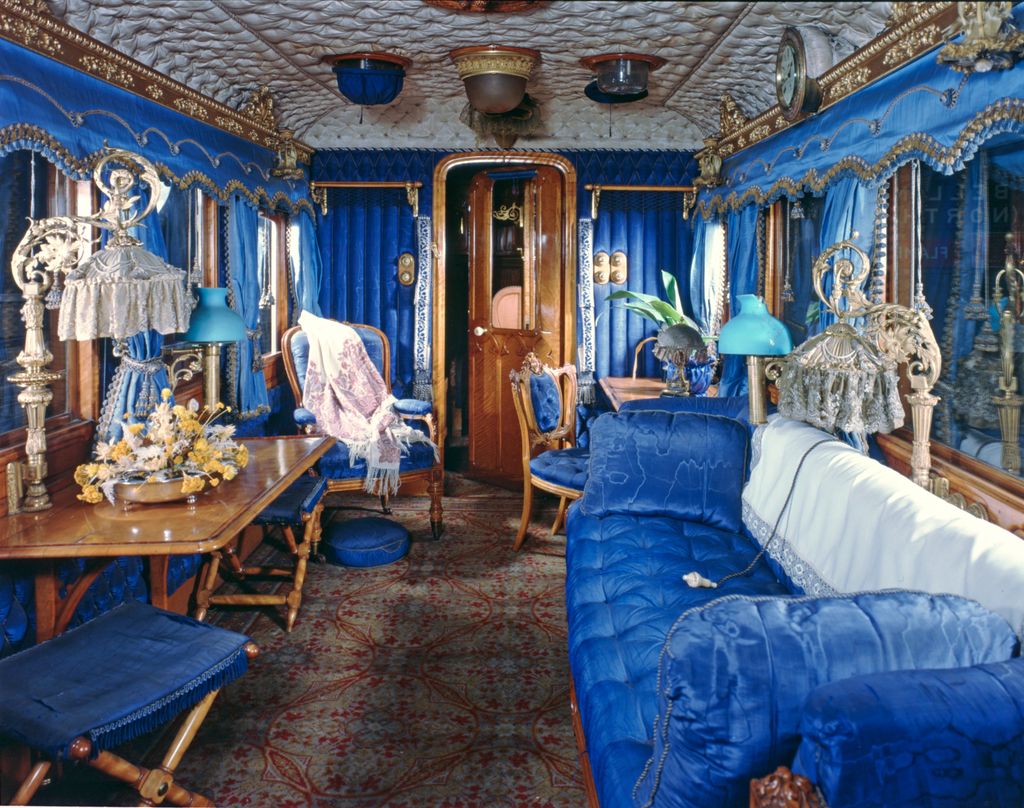 Blue velvet sofa and curtains inside the royal train