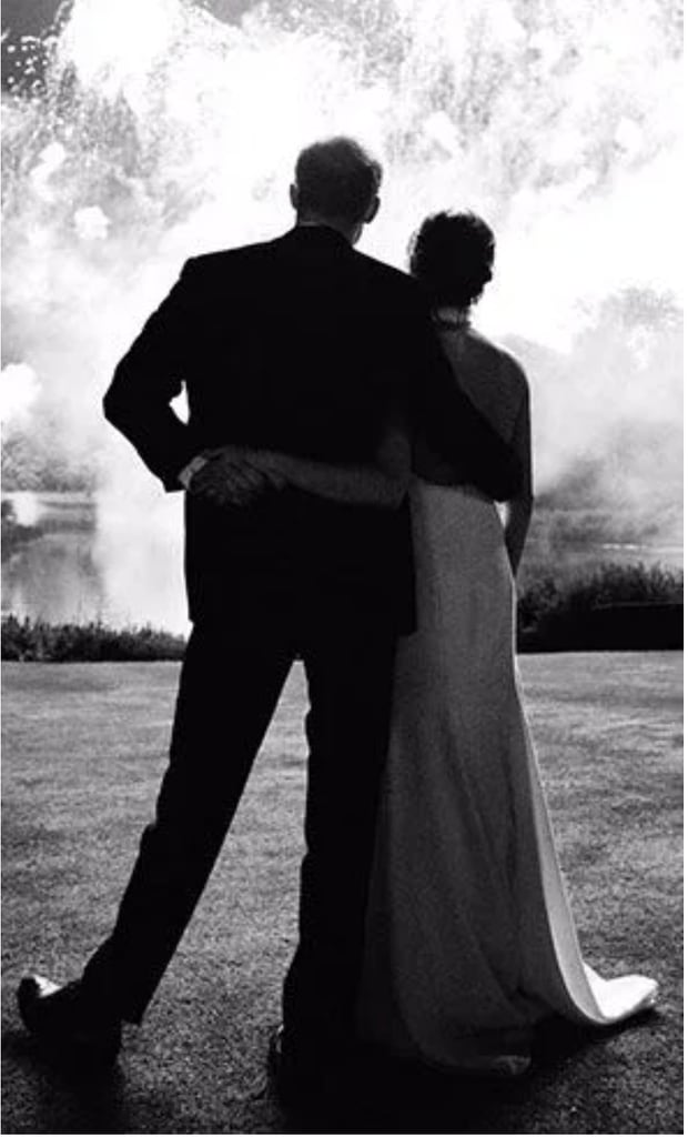 A black and white photo of Prince Harry aand Meghan Markle watching fireworks