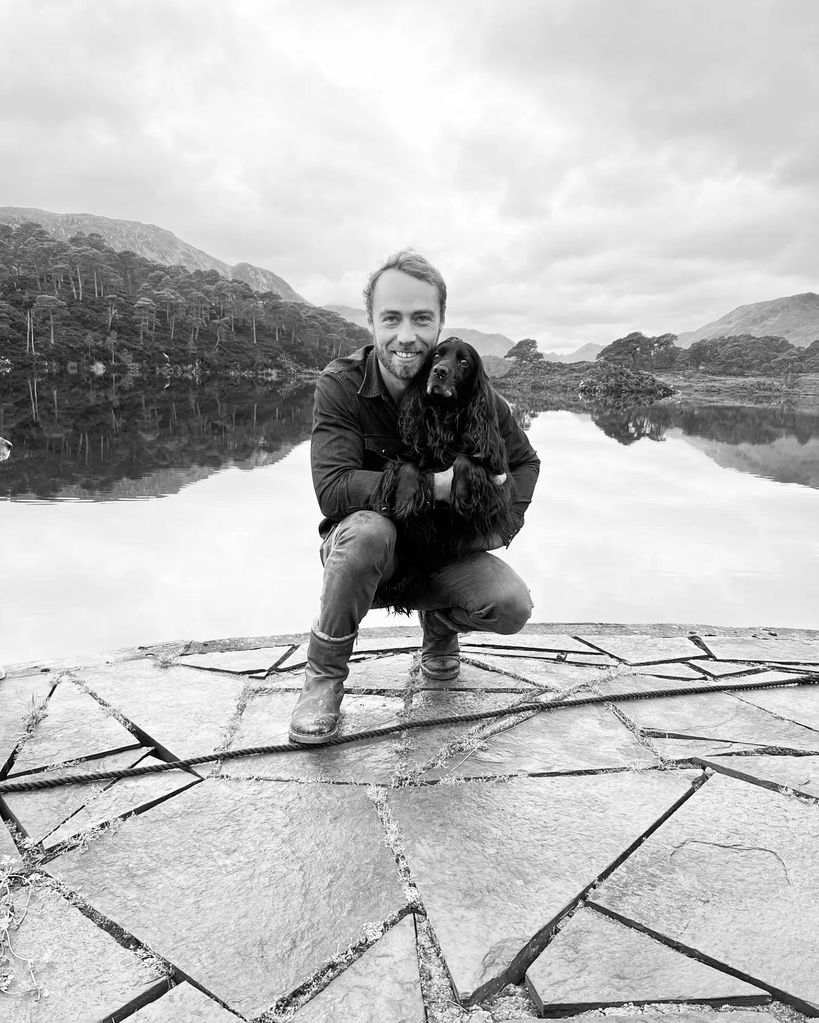 A black and white photo of James Middleton cuddling his dog Ella