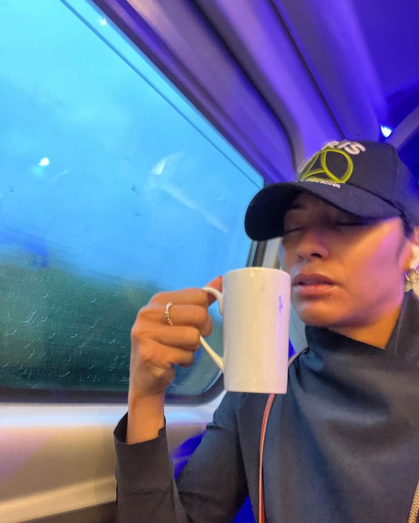 Karen Hauer sipping coffee on train 