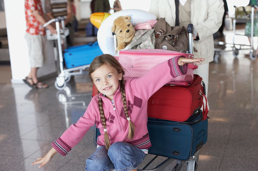 girl pretending to be an areoplane at airport 