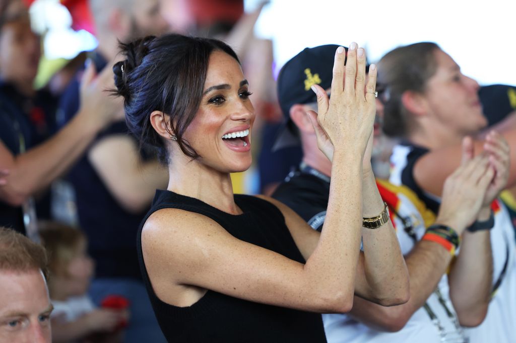 Meghan Markle applauding in black outfit