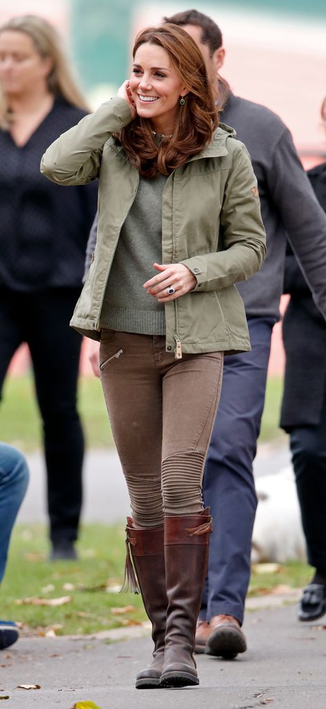kate in brown jeans, khaki anorak and boots