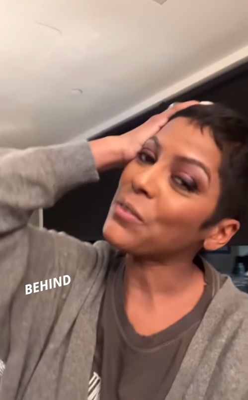 Tamron Hall in a gray sweater and Whitney Houston T-shirt