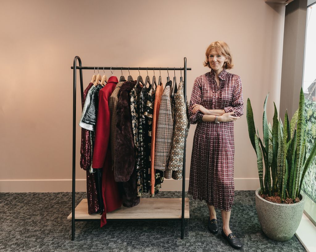 Alexandra standing next to a clothes rail