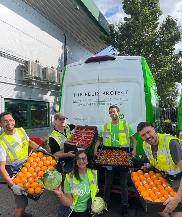 The Felix Project volunteers holding crates of fruit