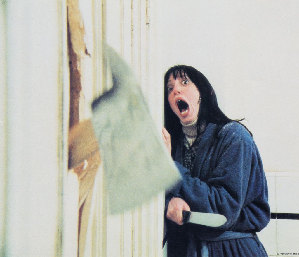 Wendy Torrance, played by American actress Shelley Duvall, recoils in shock as her husband chops through the bathroom door with a fire axe in a scene from 'The Shining', directed by Stanley Kubrick, 1980