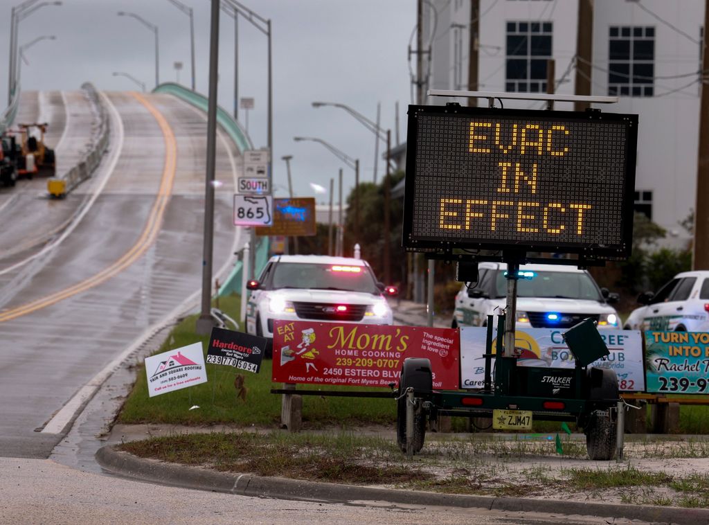 A sign indicates that an evacuation order is in effect for the beach area before Hurricane Milton's arrival on October 08, 2024, in Fort Myers, Florida. People are preparing for the storm, which could be a Cat 3 when it makes landfall on Wednesday evening