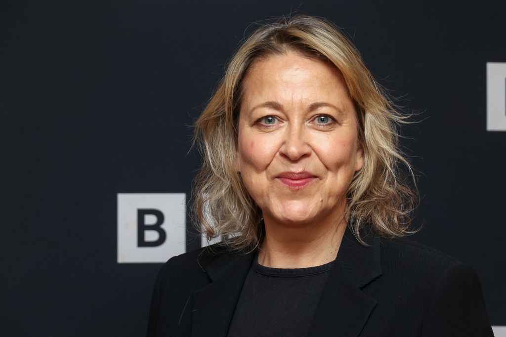close-up of blonde woman smiling at photo call 