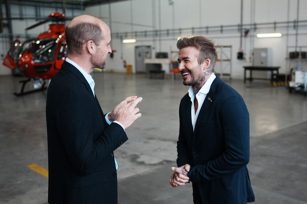 Prince William, Prince of Wales speaks with David Beckham as he arrives for a visit to RAF Northolt