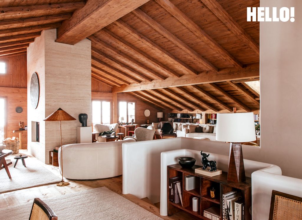 A double-height living room with a large white stone pillar