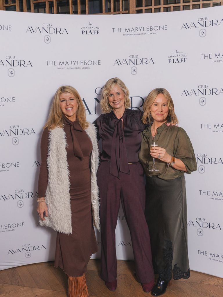 three women smiling in smart clothes
