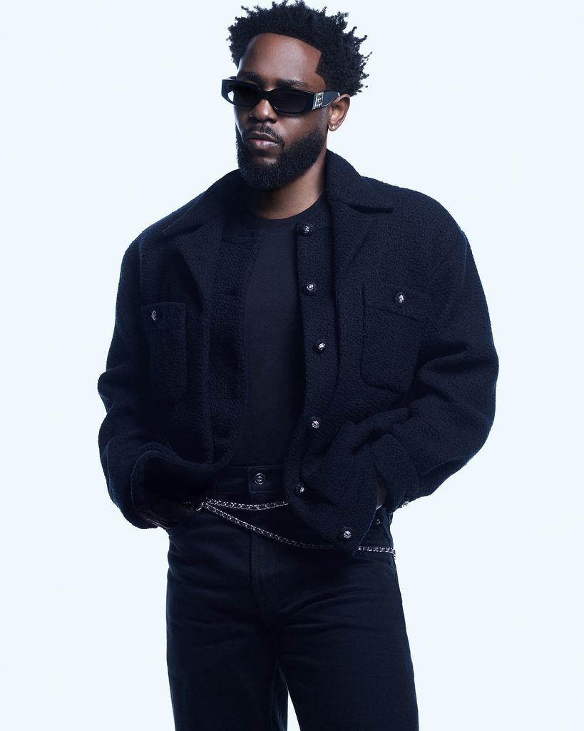 An image of Kendrick Lamar wearing a pair of Chanel sunglasses with a navy bomber jacket and jeans