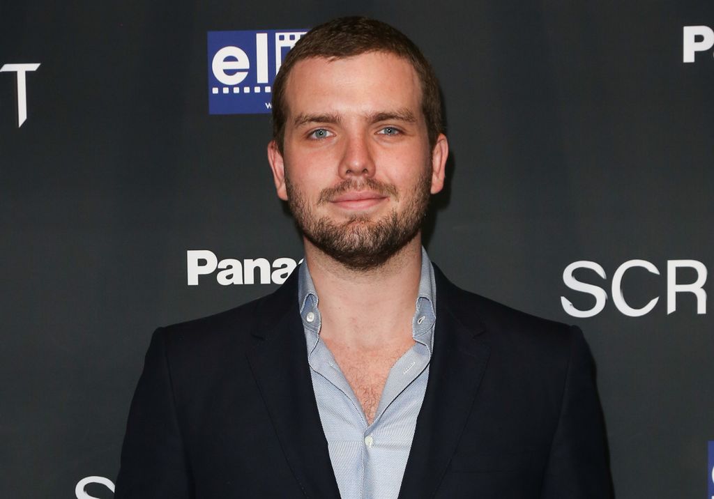 Austin smiling on the red carpet at the premiere for We Summon The Darkness