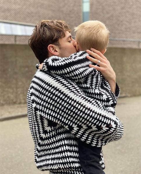 Tom Daley kissing son while wearing matching cardigans
