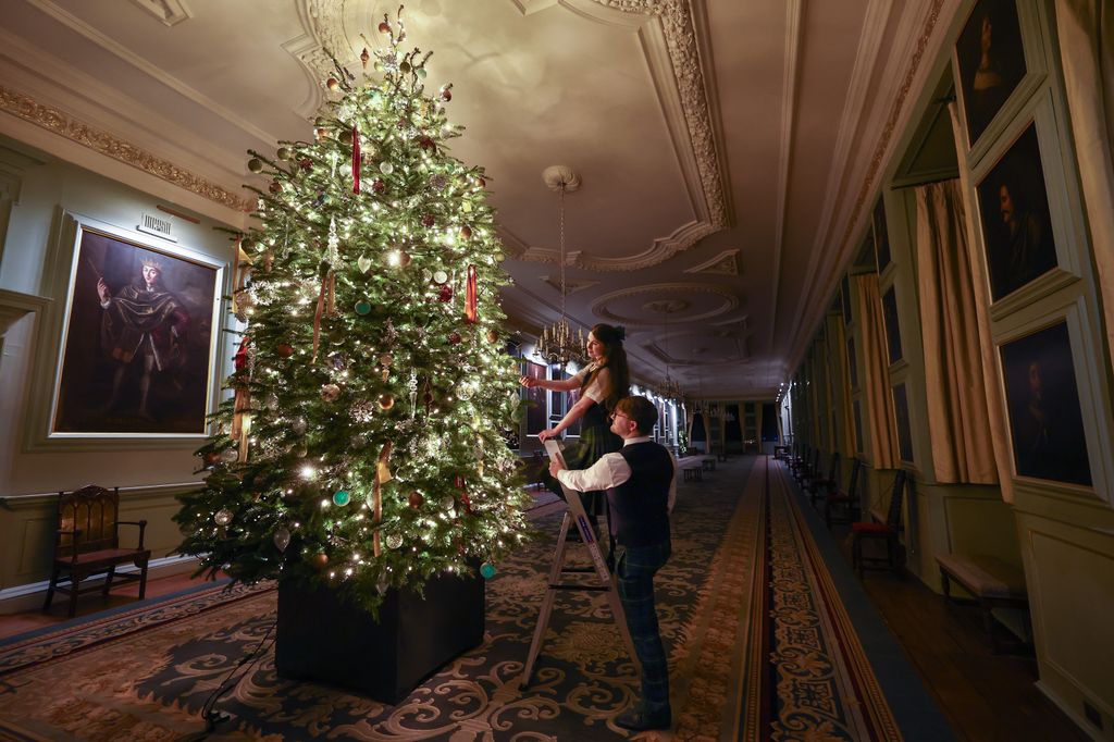 two employees finish off the christmas decorations