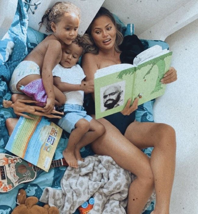 Chrissy Teigen reads a book with her children 