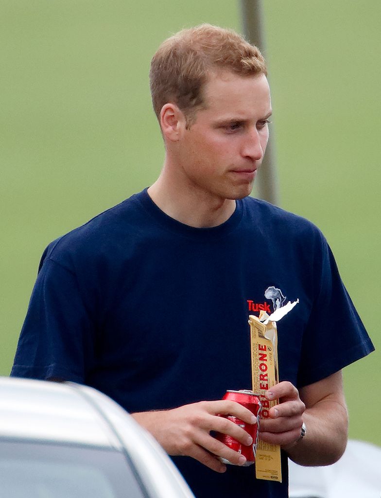 Prince William holding a bar of Tobelerone and a can of Coke